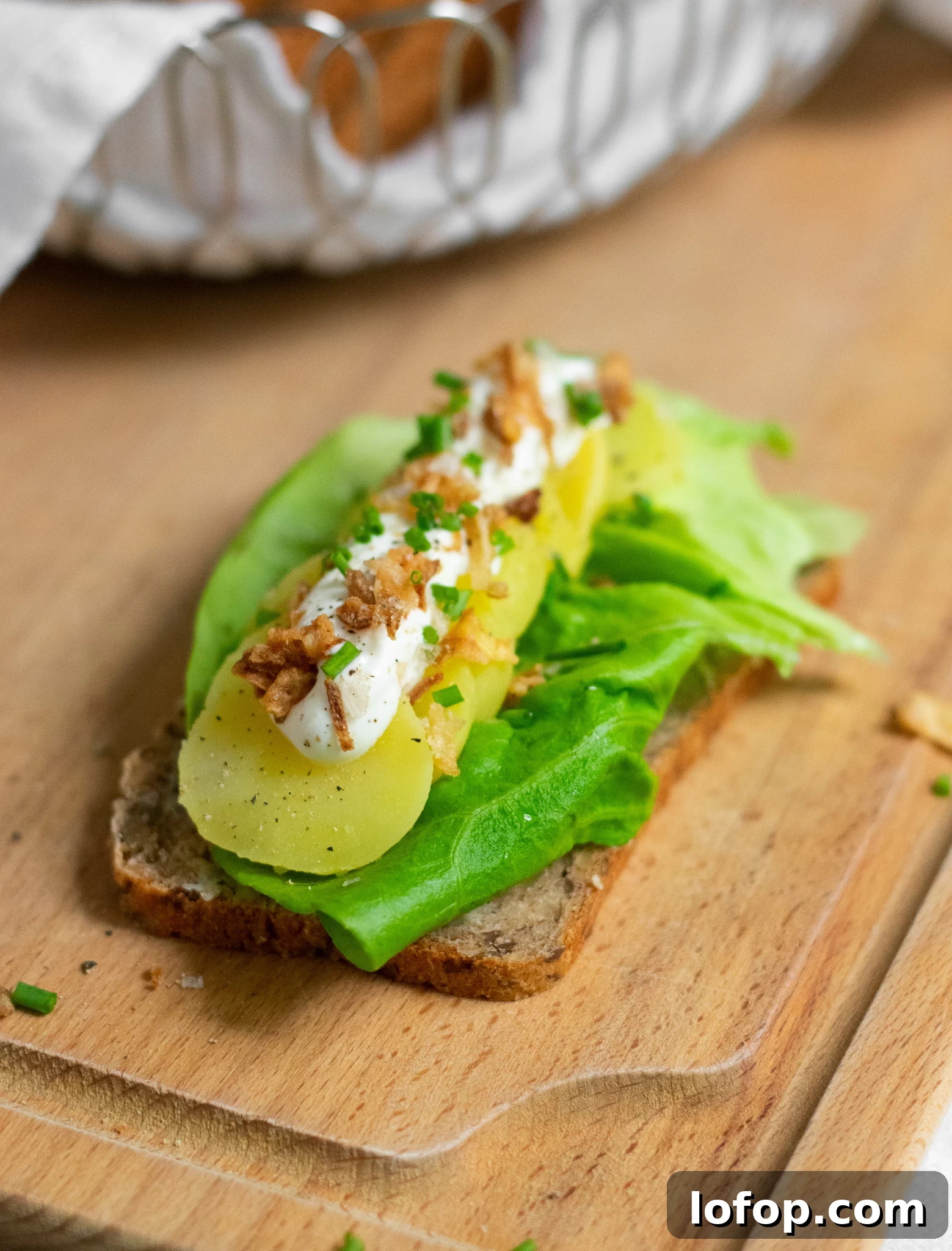 Smørrebrød: Traditional Danish Open-Faced Sandwich Recipes 37 A rye bread open faced sandwich topped with lettuce, potato, sour cream, chives, and fried onion.