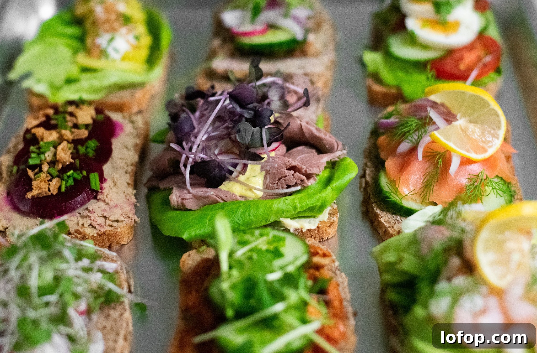 Smørrebrød: Traditional Danish Open-Faced Sandwich Recipes 38 Danish open faced sandwiches on a platter.