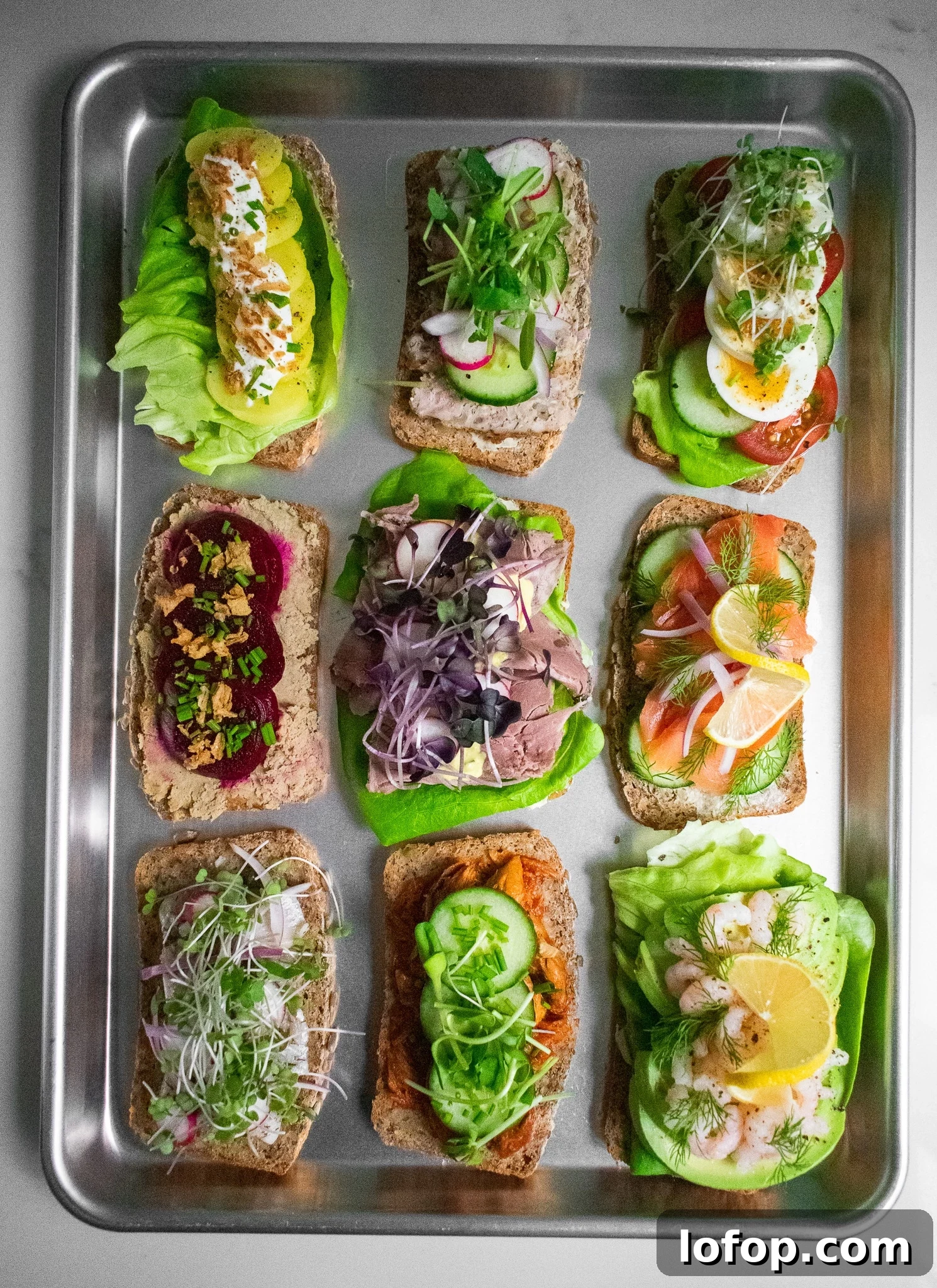 Smørrebrød: Traditional Danish Open-Faced Sandwich Recipes 8 Danish open faced sandwiches on a platter.