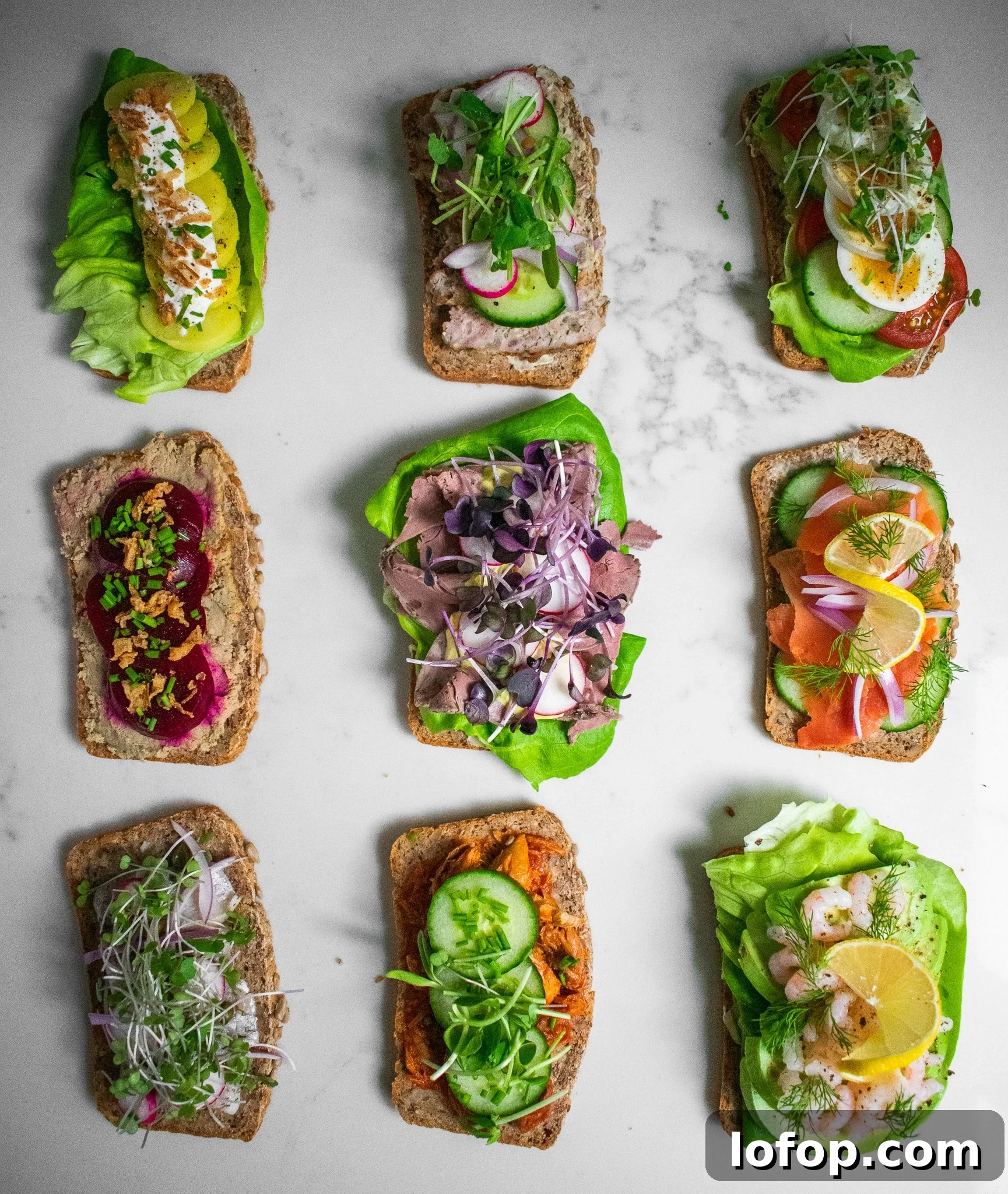 Smørrebrød: Traditional Danish Open-Faced Sandwich Recipes 10 Danish open faced sandwiches on a platter.
