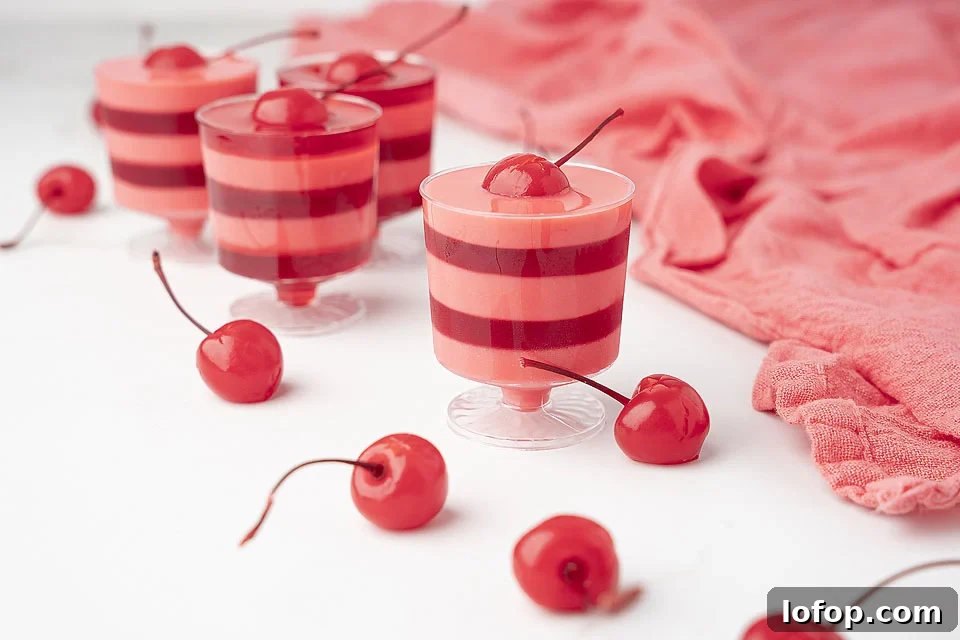 29 Jello Shot Recipes to Kick Off Any Party Night 3 A group of red and white striped cups with cherries in them.