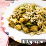 Plate of summer vegetable pasta with basil pesto.