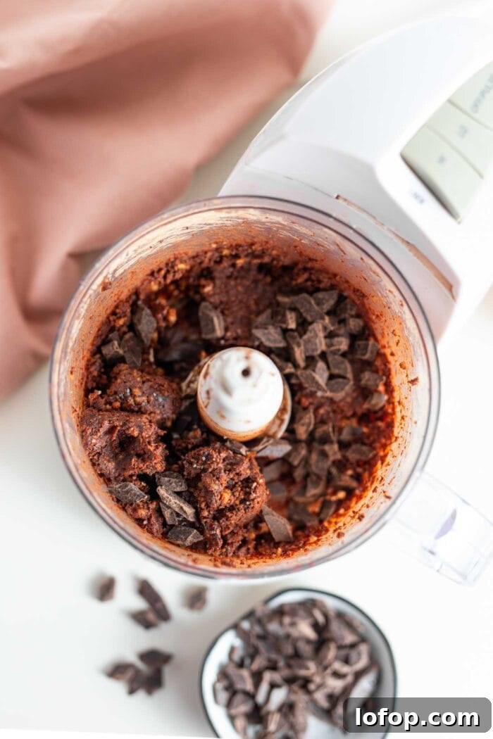 Vegan No-Bake Chocolate Brownies — Quick Raw Dessert Recipe 6 Dark chocolate chunks in a food processor with a thick chocolate dough.
