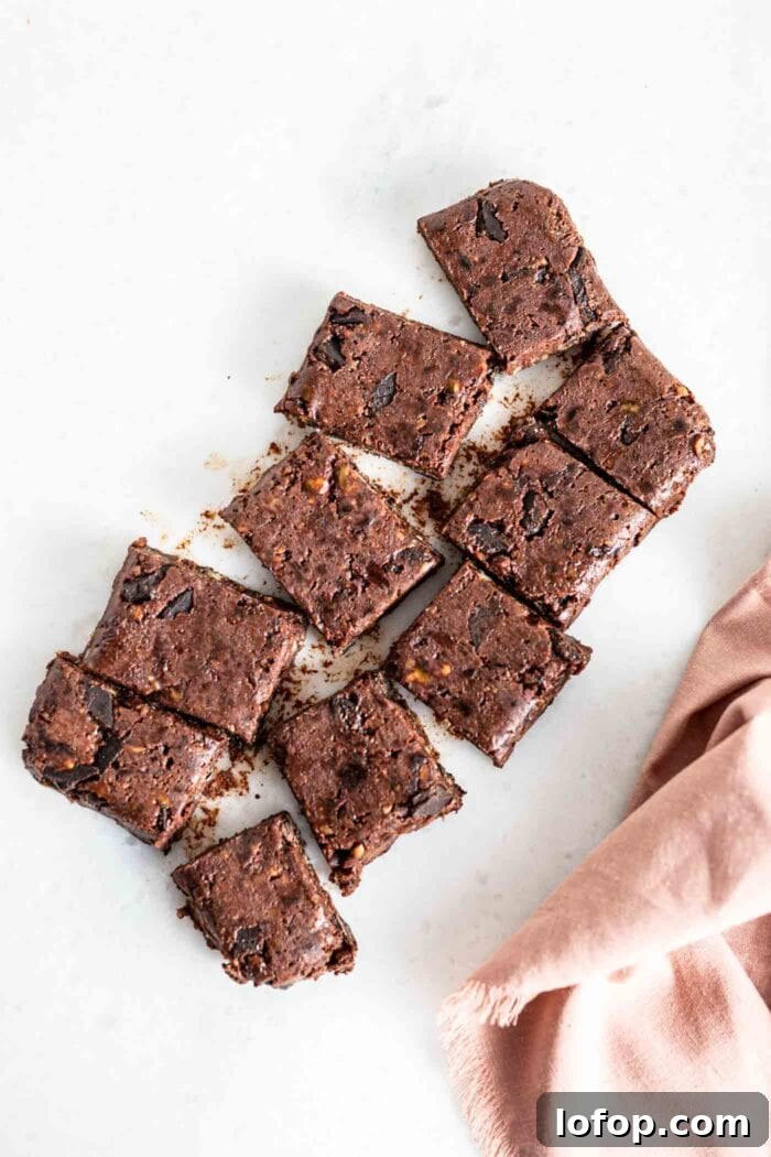 Vegan No-Bake Chocolate Brownies — Quick Raw Dessert Recipe 8 An overhead image of a slab of brownies sliced into 8 pieces.