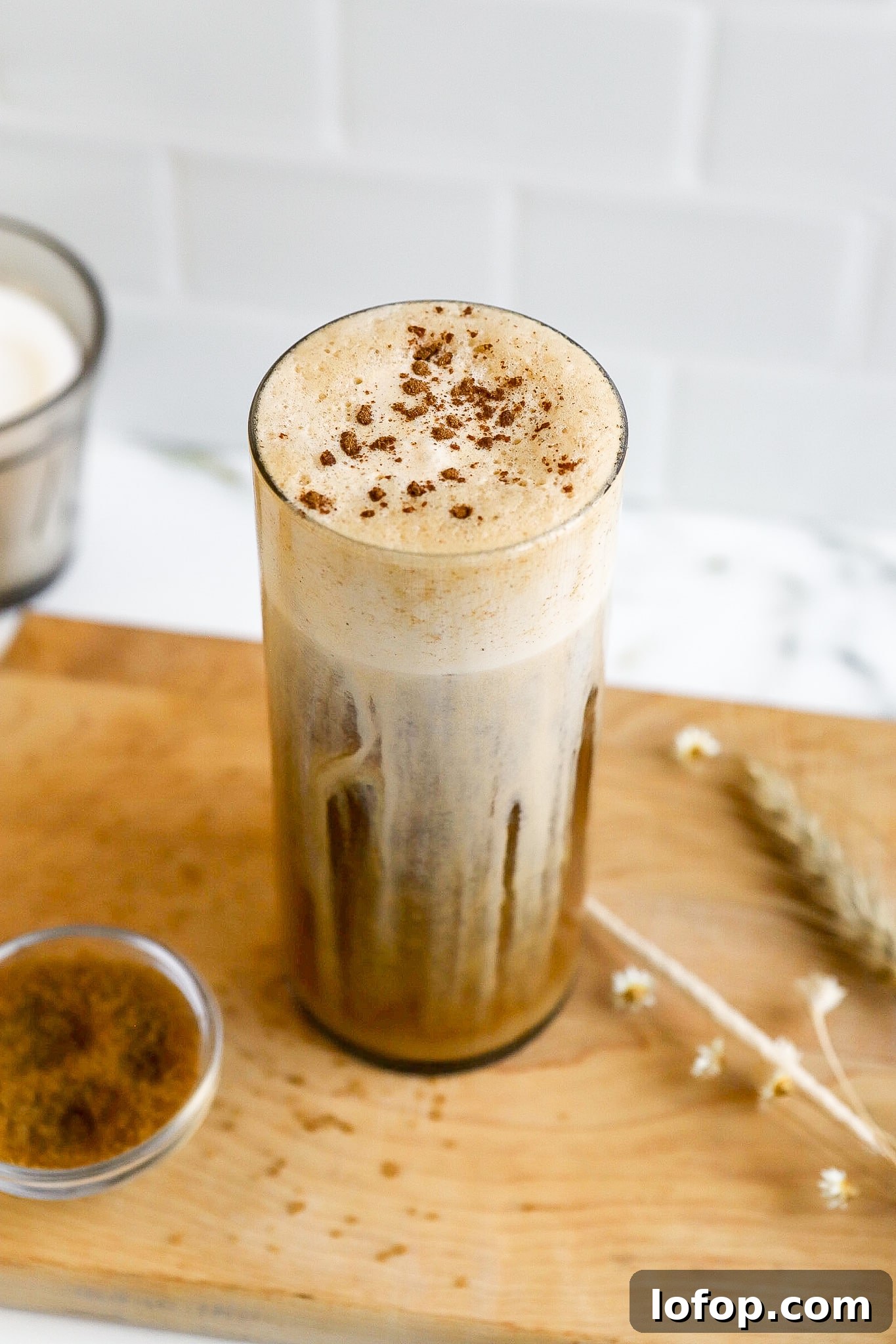 Starbucks Pumpkin Cream Cold Foam Recipe (Copycat) 2 side view of cold coffee in glass with pumpkin spice topping and cinnamon