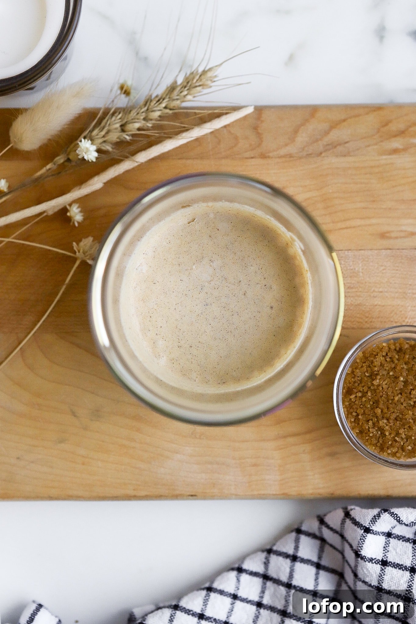 Starbucks Pumpkin Cream Cold Foam Recipe (Copycat) 4 top down view of starbucks pumpkin cream cold brew in short glass on cutting board