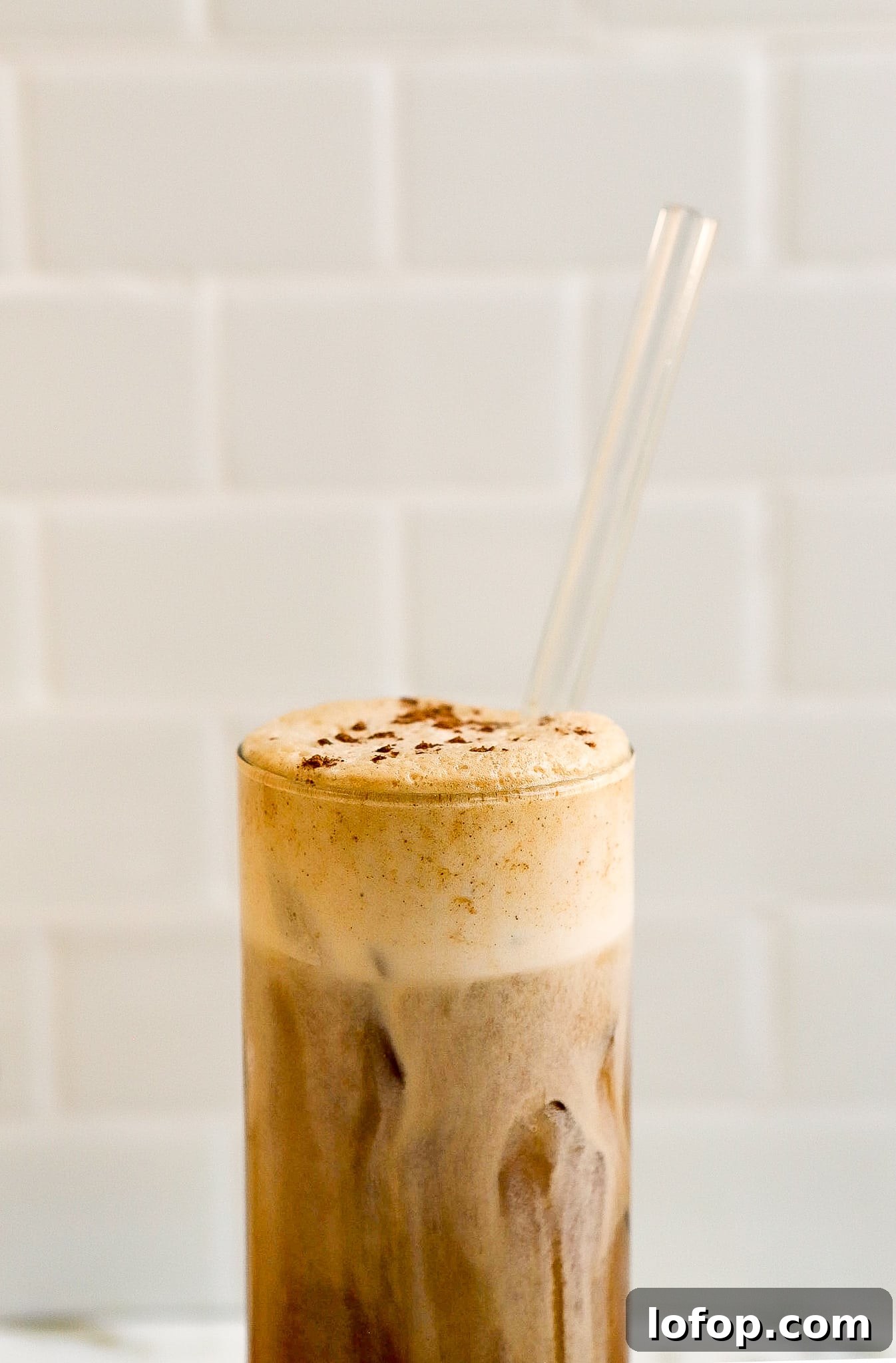 Starbucks Pumpkin Cream Cold Foam Recipe (Copycat) 5 side angle of sweet pumpkin cream in glass with glass straw
